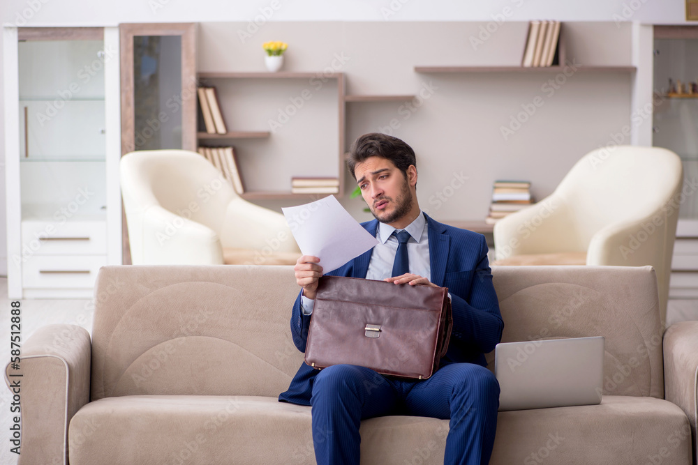 Young male employee working from home during pandemic Young male employee working from home during pandemic