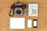 Vintage and modern phones on table
