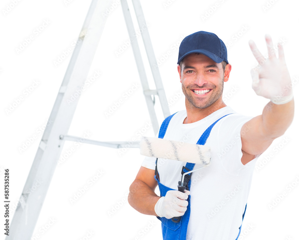 Happy handyman with paint roller gesturing okay