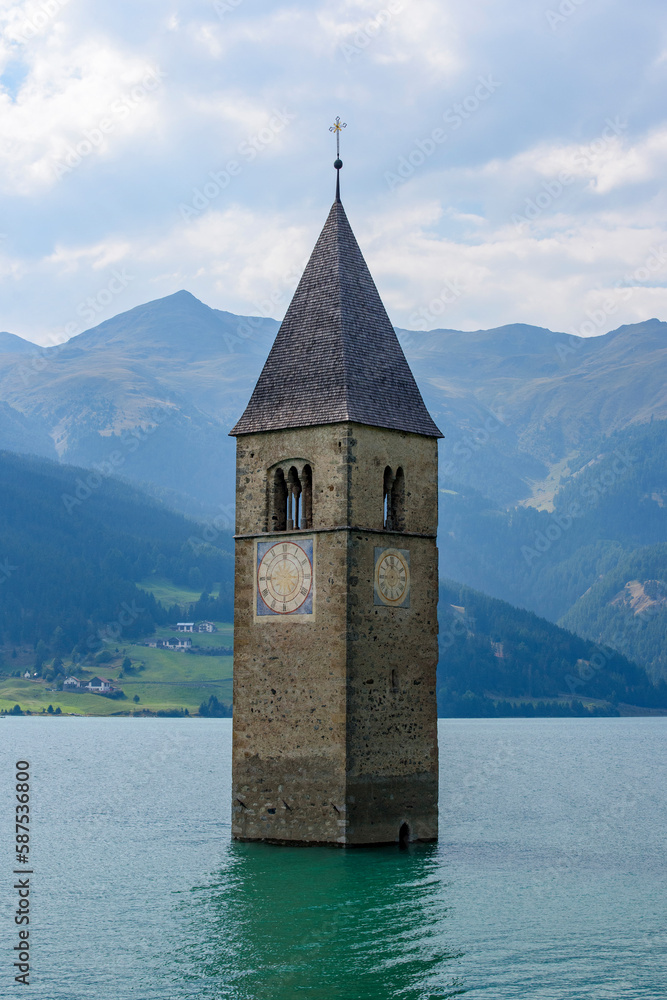 Medieval church bell tower rising from Lake Resia. Italy