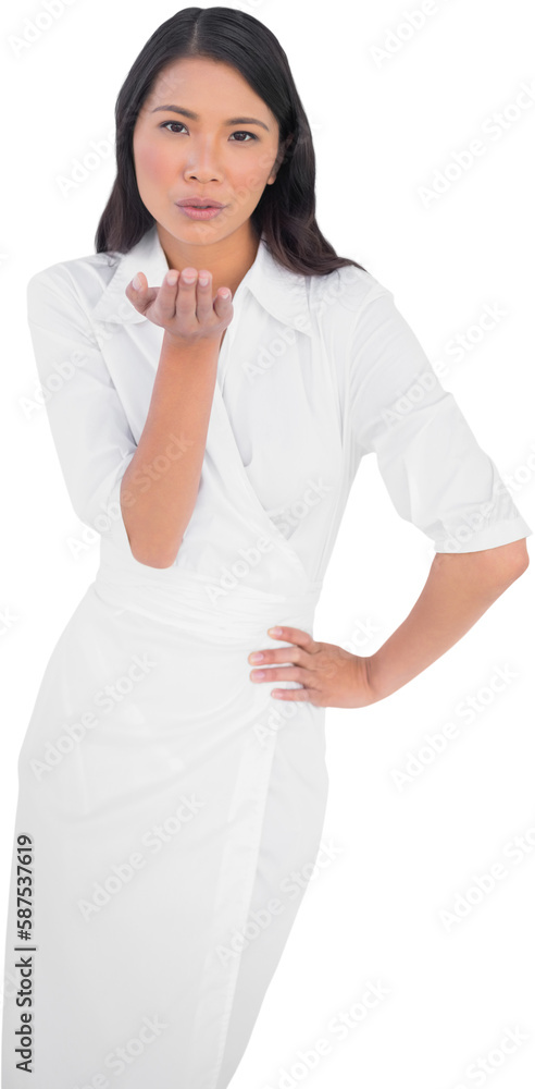 Elegant dark haired model wearing white dress kissing camera Elegant dark haired model wearing white dress kissing camera
