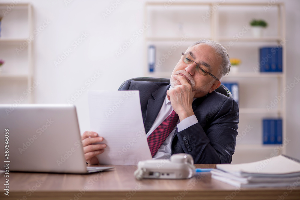 Old male employee and too much work in the office Old male employee and too much work in the office