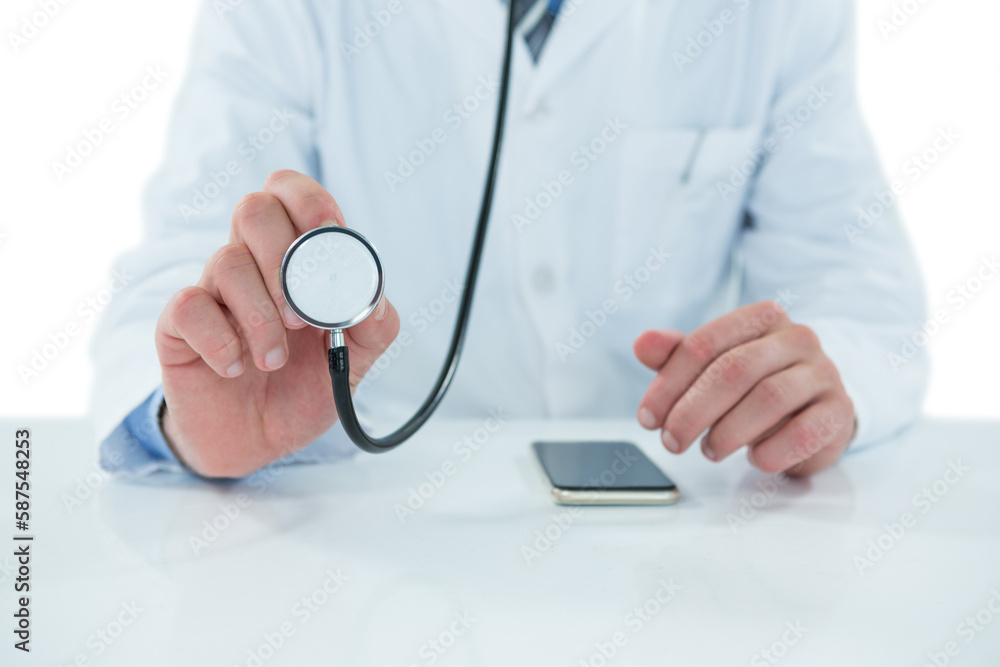 Midsection of doctor holding stethoscope Midsection of doctor holding stethoscope