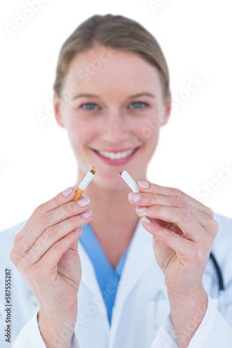 Doctor holding broken cigarette 