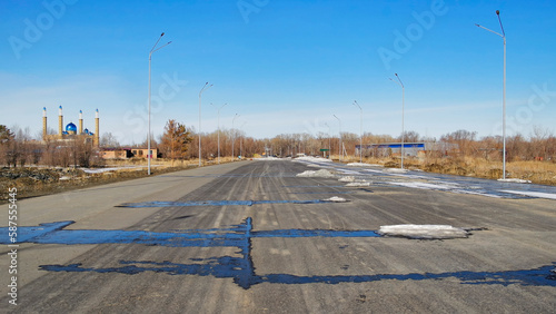 Newly built road. Road under construction. New area in the city. Big avenue. Urbanization. Spring 2023. Ust-Kamenogorsk (kazkahstan) photo