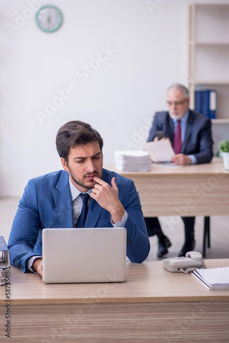 Two male colleagues working in the office