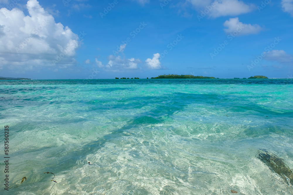 Crystal clear turquoise ocean water and remote tropical islands in