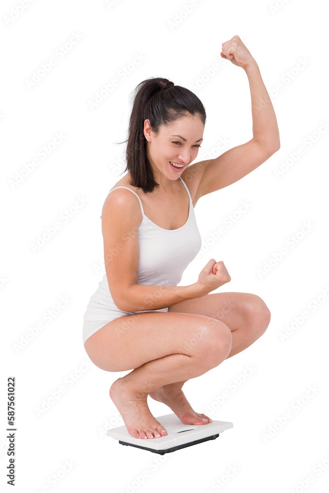 Obraz premium Beautiful woman cheering on weighing scales