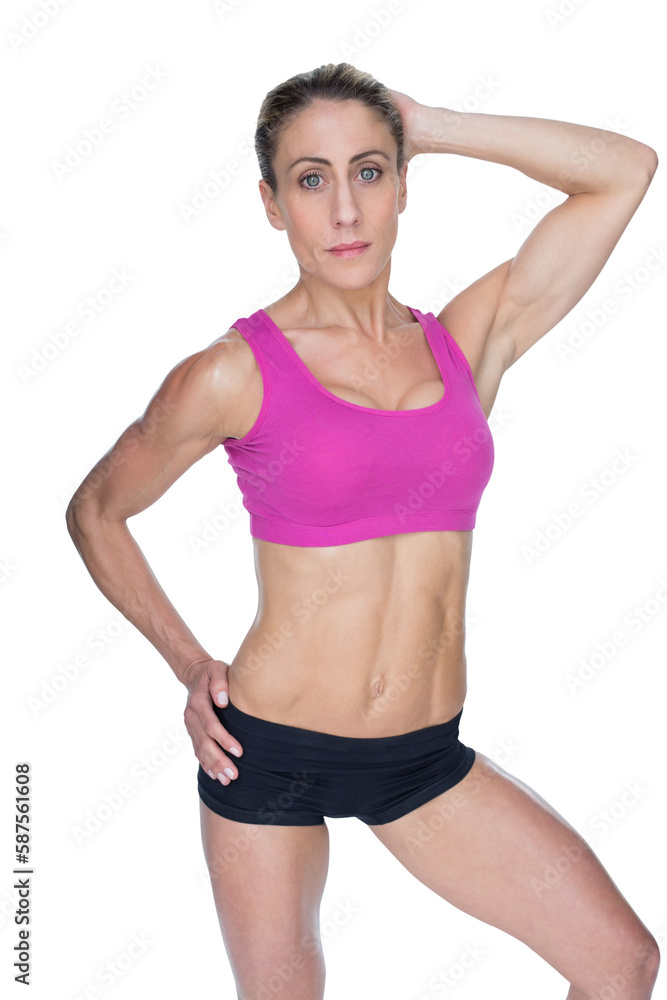 Female bodybuilder posing in pink sports bra