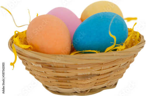 Colorful Easter eggs in wicker basket 