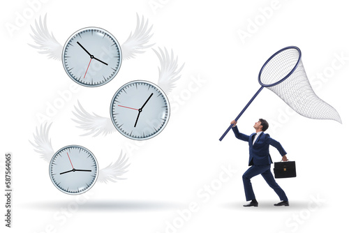 Deadline concept with businessman catching clocks photo