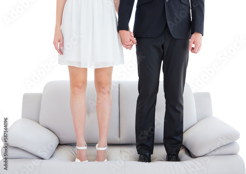 Low section of couple standing on sofa  © vectorfusionart