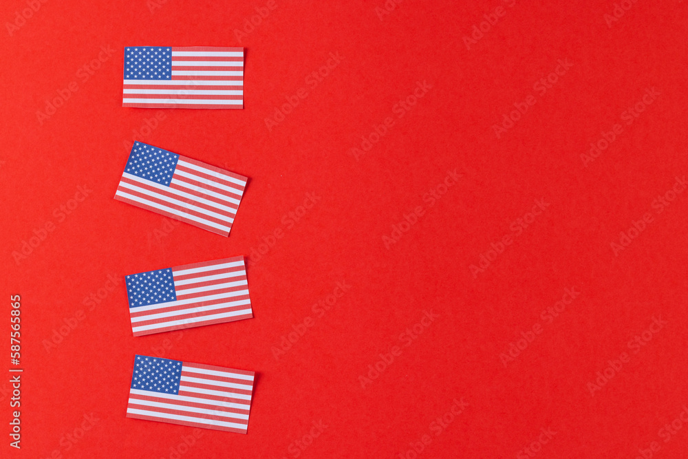 High angle view of four flags of united states of america with copy space on red background