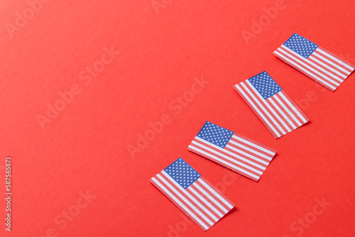 High angle view of four flags of united states of america with copy space on red background