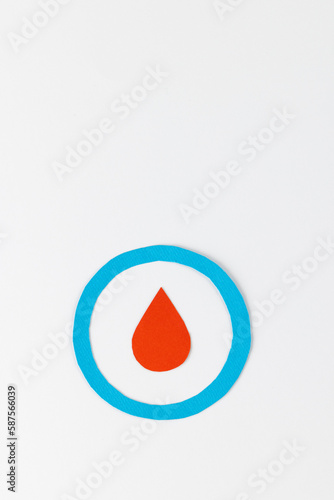Blood drop in blue ring on white background with copy space