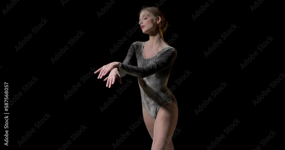 Dancing in flour concept.Beautiful caucasian female woman dancer in dust, fog wearing black bodysuit, making dance element in flour cloud on isolated black studio background, moves arms smoothly Dancing in flour concept.Beautiful caucasian female woman dancer in dust, fog wearing black bodysuit, making dance element in flour cloud on isolated black studio background, moves arms smoothly