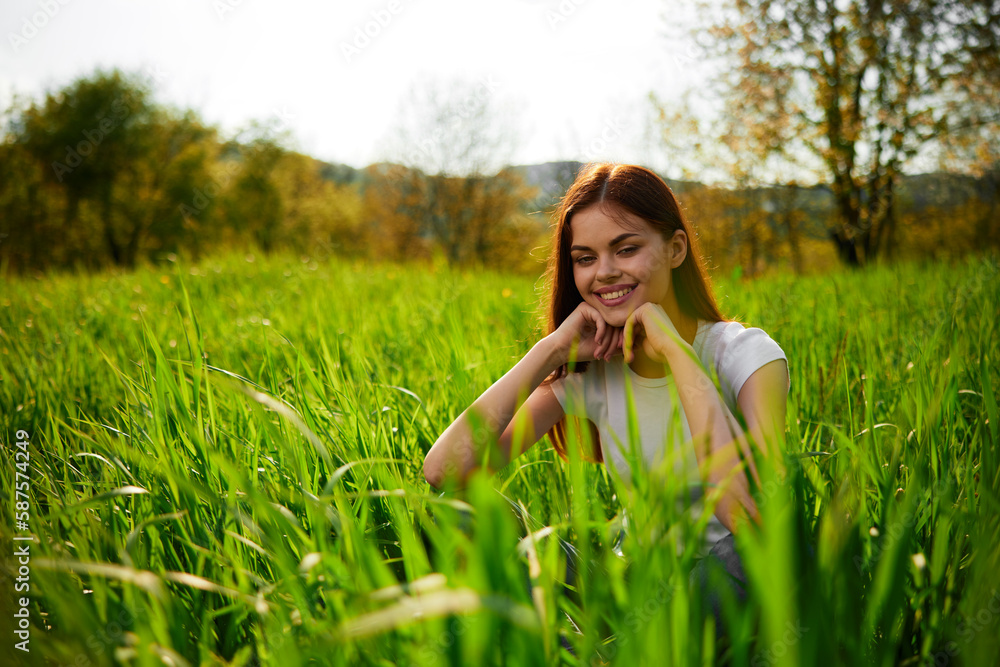 portrait of a happy woman in a white t-shirt with her hands folded in front of her face portrait of a happy woman in a white t-shirt with her hands folded in front of her face