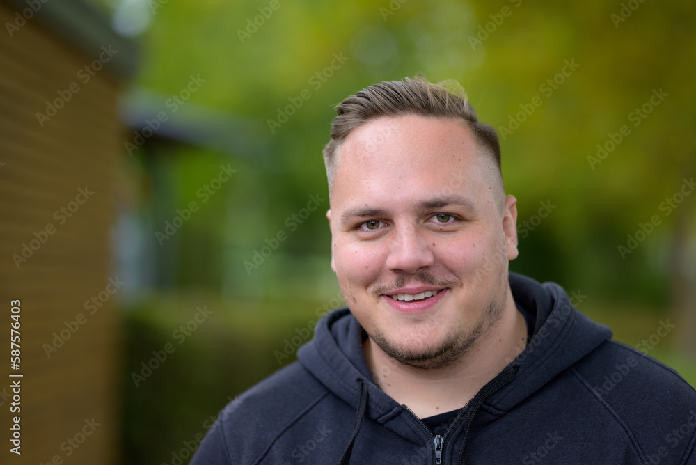Young man standing in a garden or park Young man standing in a garden or park