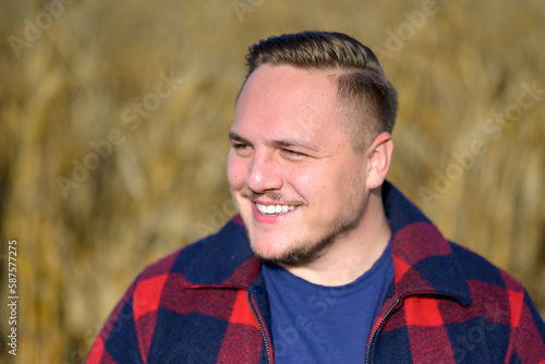 Young man in front of an autumn corn field