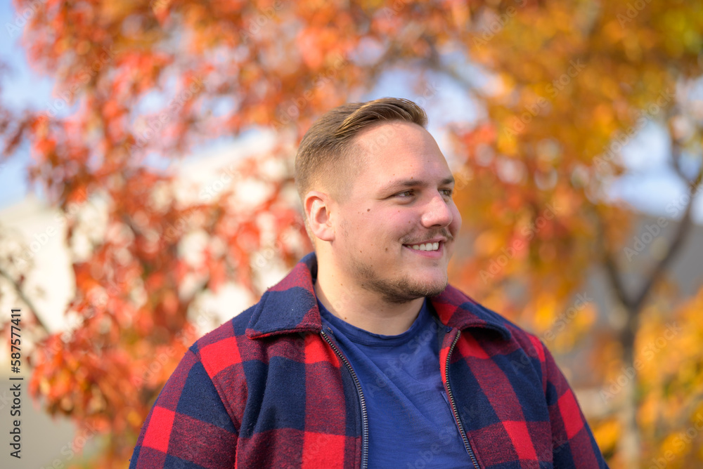 Young man in front of an autumn background Young man in front of an autumn background