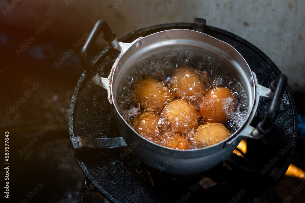 Saucepan with boiling eggs on a gas stove in the morning