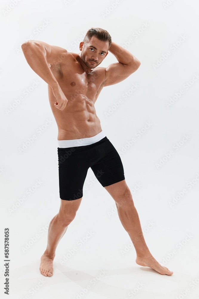 Man athletic body bodybuilder in briefs with naked torso abs full-length in the background, fitness classes. Advertising, sports, active lifestyle, competition, challenge concept. Man athletic body bodybuilder in briefs with naked torso abs full-length in the background, fitness classes. Advertising, sports, active lifestyle, competition, challenge concept.