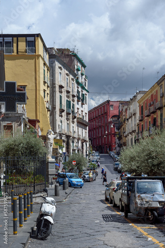 Naples, Italy. View of Via Montesanto. On the left the statue of Jesus of the Church of Santa Maria di Montesanto. Vertical image. 2022-08-20.