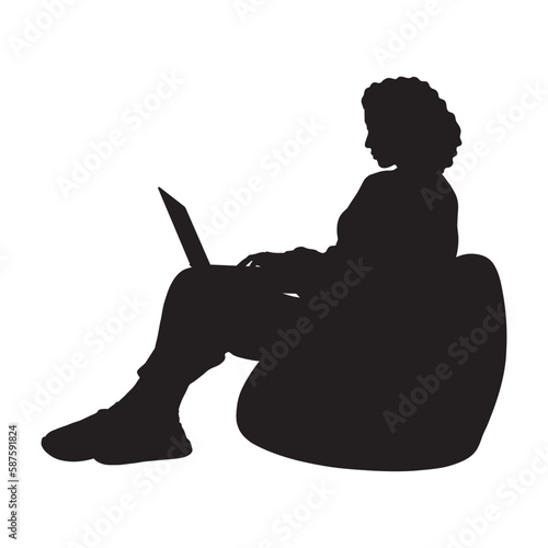 Curly hair woman with laptop sitting on bean bag silhouette.