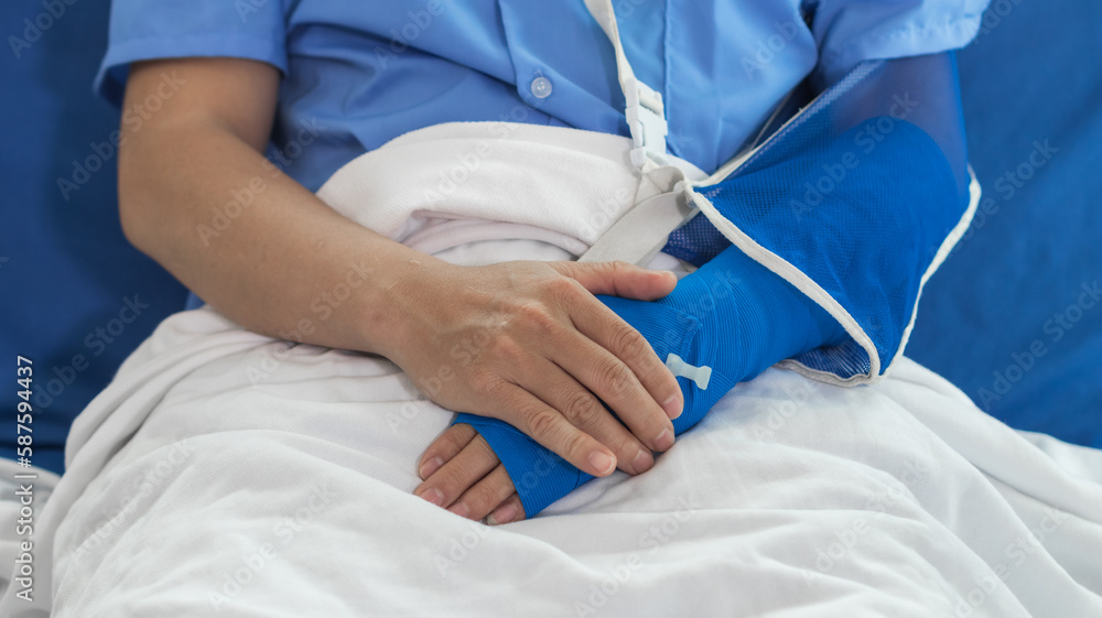 Fototapeta premium Cropped image of doctor in uniform with stethoscope using tablet standing in hospital with patient lying in bed on background Operator checks patient information on digital tablet