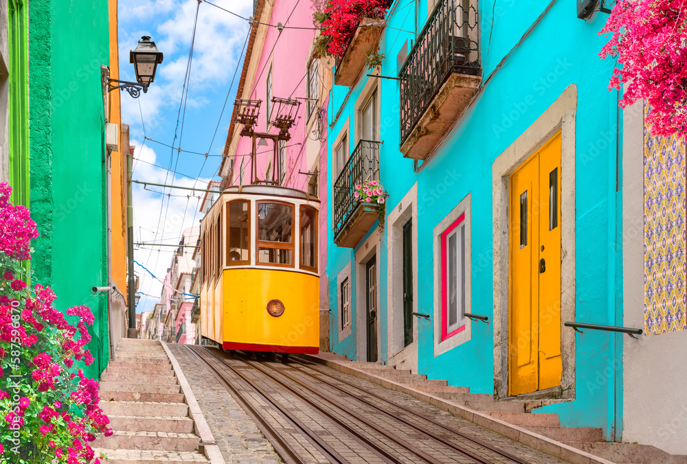 Lisbon, Portugal - Yellow tram on a street with colorful houses and flowers on the balconies - Bica Elevator going down the hill of Chiado. - obrazy, fototapety, plakaty 