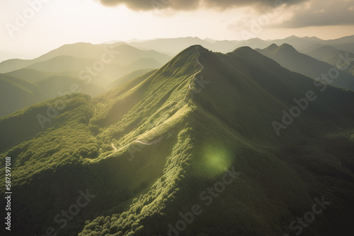 Beautiful sunrise over the green mountains in morning light with fluffy clouds on a bright blue sky. Nature freshness concept