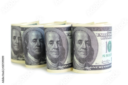 Twisted one hundred dollar bills stand on a white background. photo