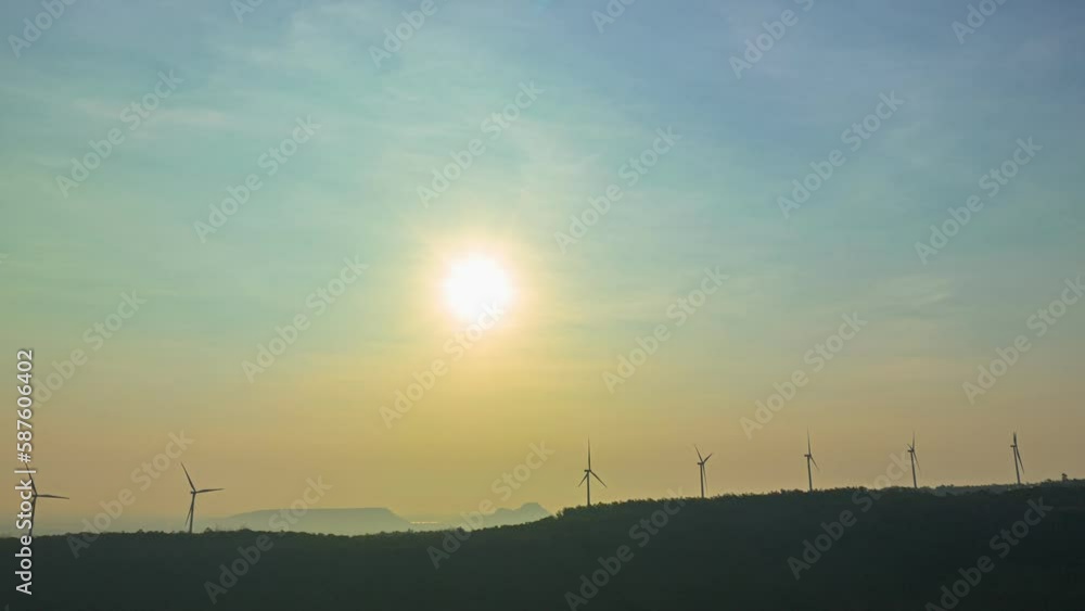 aerial hyperlapse view beautiful sunrise above wind turbines..scenery sky in the morning above the large dam..wind turbine on the top of mountain.Wind power generates electricity. Clean energy aerial hyperlapse view beautiful sunrise above wind turbines..scenery sky in the morning above the large dam..wind turbine on the top of mountain.Wind power generates electricity. Clean energy
