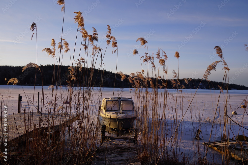 Fototapeta premium Boat on a frozen lake