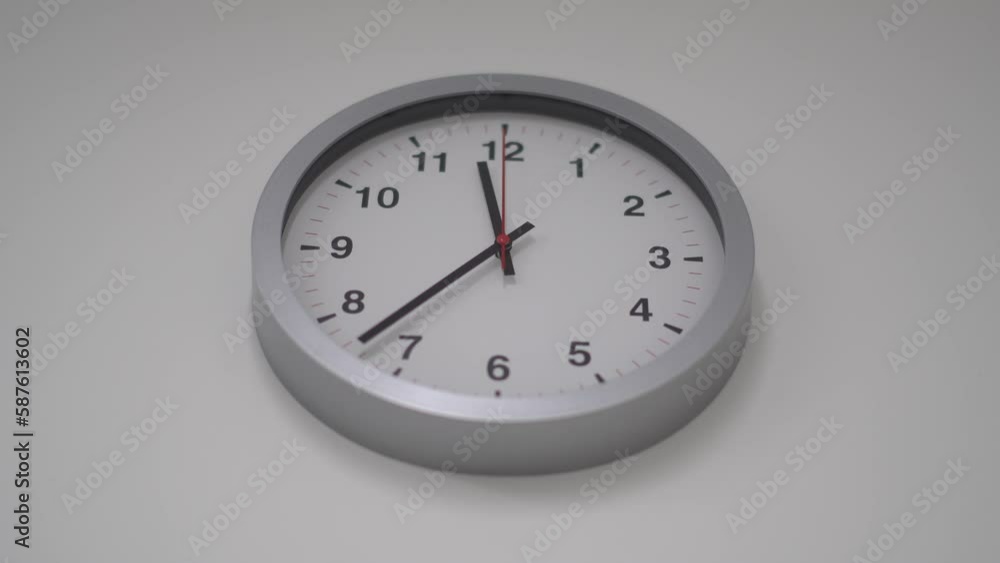 Classic round wall clock on the white wall background. Classic round wall clock on the white wall background.