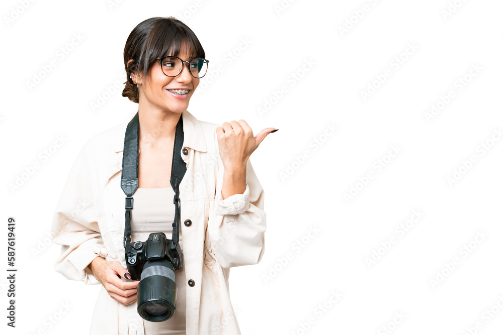 Young photographer caucasian woman over isolated chroma key background pointing to the side to present a product Young photographer caucasian woman over isolated chroma key background pointing to the side to present a product