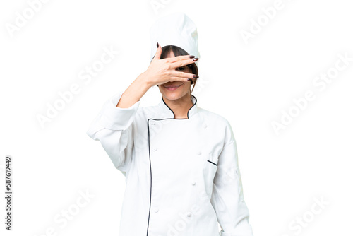 Young caucasian chef woman over isolated chroma key background covering eyes by hands and smiling
