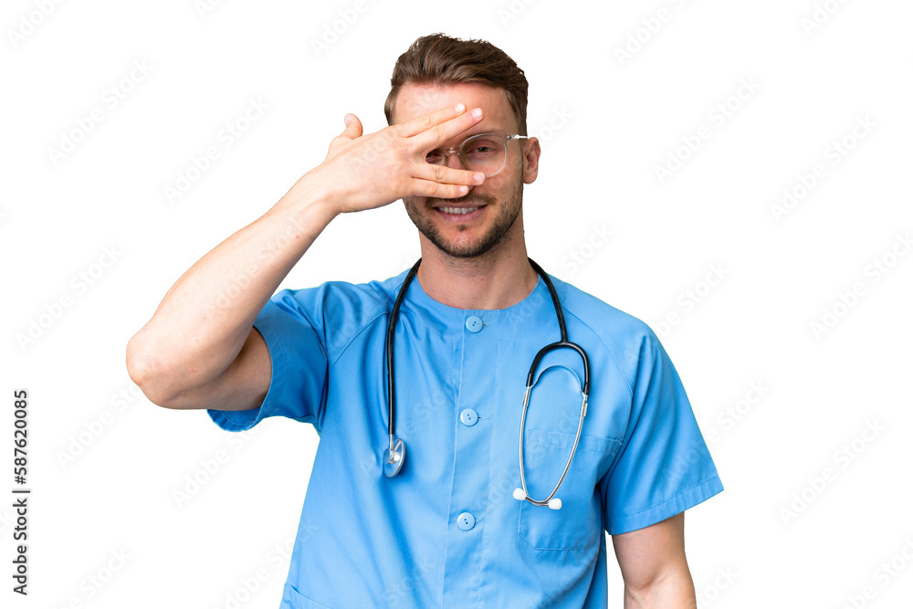 Young nurse man over isolated chroma key background covering eyes by hands and smiling