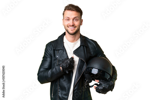 Young caucasian man with a motorcycle helmet over isolated chroma key background with surprise facial expression