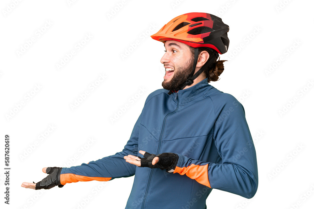 Young cyclist man over isolated chroma key background with surprise facial expression - obrazy, fototapety, plakaty 