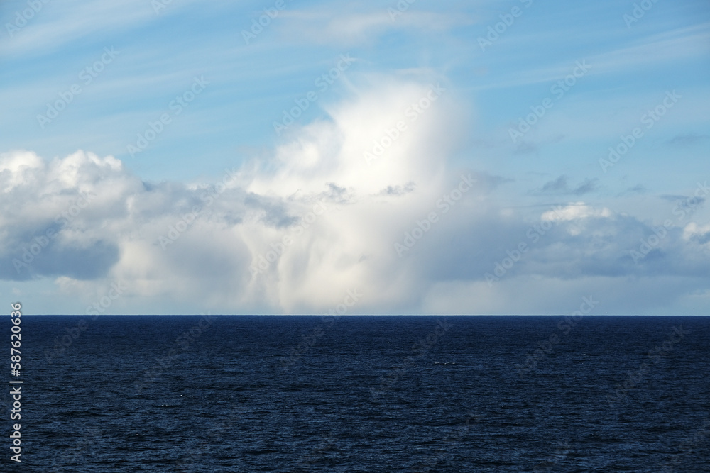 Scenic panoramic seascape view of Ocean and clouds on blue sky on sunny day at sea seen from outdoor deck of luxury cruiseship cruise ship liner Scenic panoramic seascape view of Ocean and clouds on blue sky on sunny day at sea seen from outdoor deck of luxury cruiseship cruise ship liner