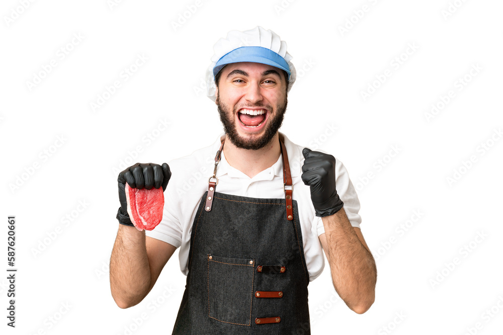 Butcher man wearing an apron and serving fresh cut meat over isolated chroma key background celebrating a victory in winner position Butcher man wearing an apron and serving fresh cut meat over isolated chroma key background celebrating a victory in winner position