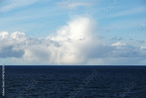 Scenic panoramic seascape view of Ocean and clouds on blue sky on sunny day at sea seen from outdoor deck of luxury cruiseship cruise ship liner