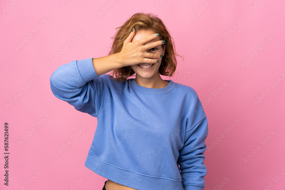Young Georgian woman isolated on pink background covering eyes by hands and smiling Young Georgian woman isolated on pink background covering eyes by hands and smiling