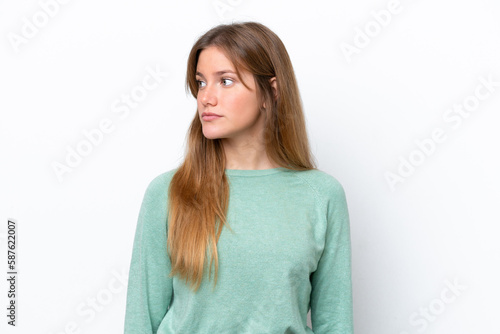 Young caucasian woman isolated on white background looking to the side © luismolinero