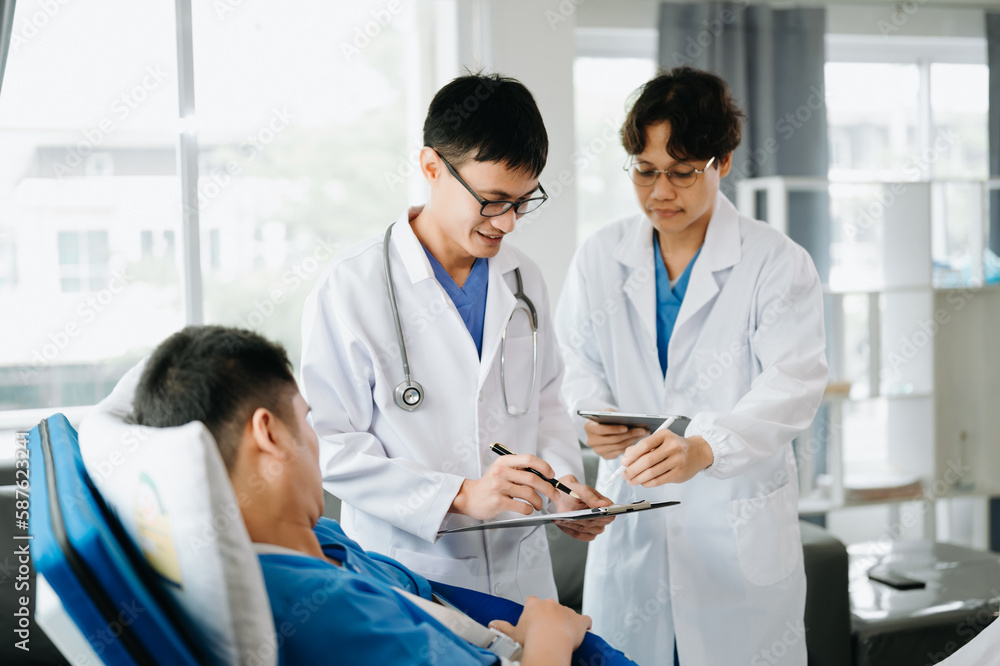 Hospital Ward Male and Femle Professional Asian Doctors Talk with a Patient, Give Health Care Advice, Recommend Treatment Plan with Advanced Equipment . Hospital Ward Male and Femle Professional Asian Doctors Talk with a Patient, Give Health Care Advice, Recommend Treatment Plan with Advanced Equipment .