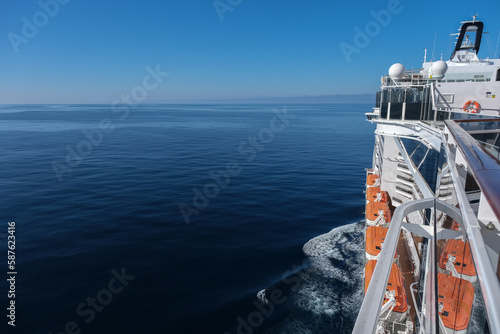 Scenic panoramic seascape view of Ocean and clouds on blue sky on sunny day at sea seen from outdoor deck of luxury cruiseship cruise ship liner
