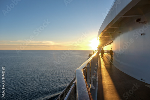 Breathtaking sunrise sunset dusk dawn twilight scenery over ocean with silhouettes of people and boats yachts seen panoramic view from cruiseship cruise ship liner during Caribbean cruising