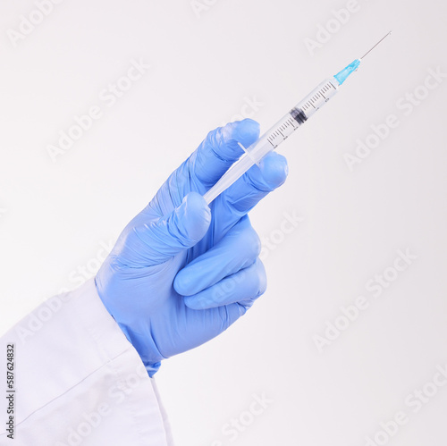 Healthcare, hand and doctor with vaccine, injection or shot in studio against a white background. Medicine, vaccination and man health expert with needle for medical, innovation or disease treatment