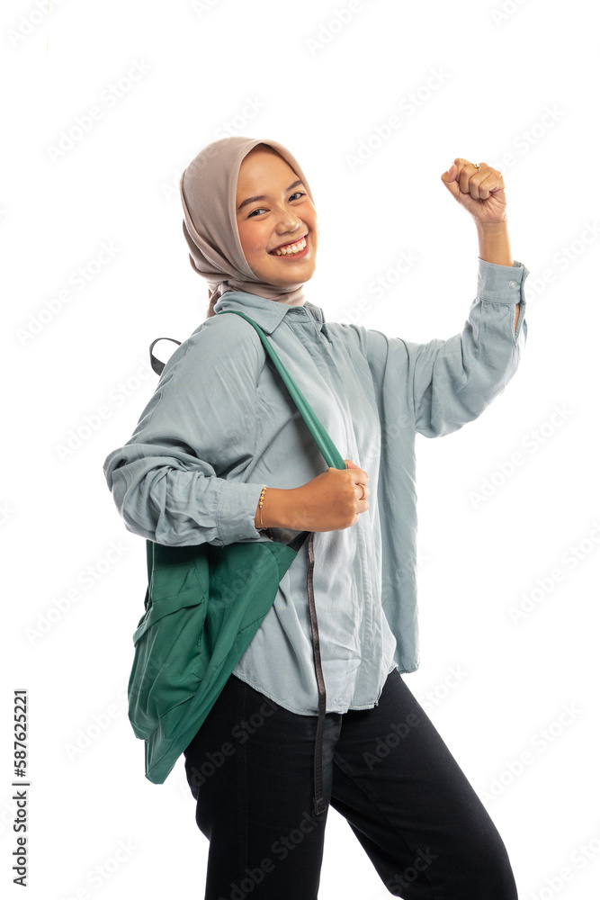 excited Asian Muslim student in hijab walking with backpack on isolated background excited Asian Muslim student in hijab walking with backpack on isolated background